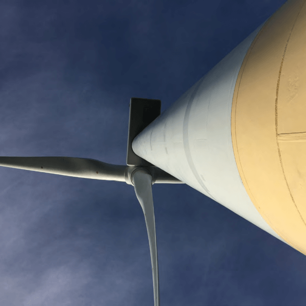 Looking upward at a wind turbine