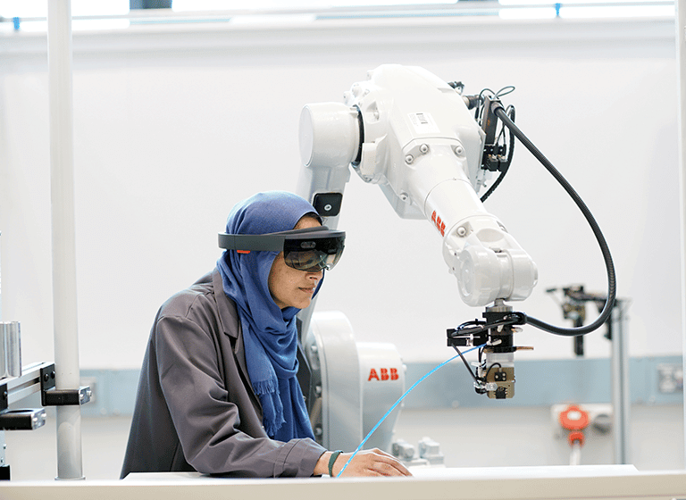 Woman weating headset with a robotic arm 