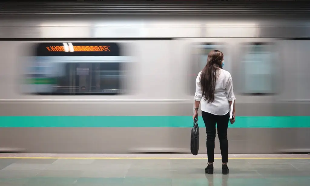 Woman standing on a train station platform