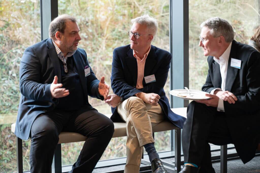 Three men in conversation 