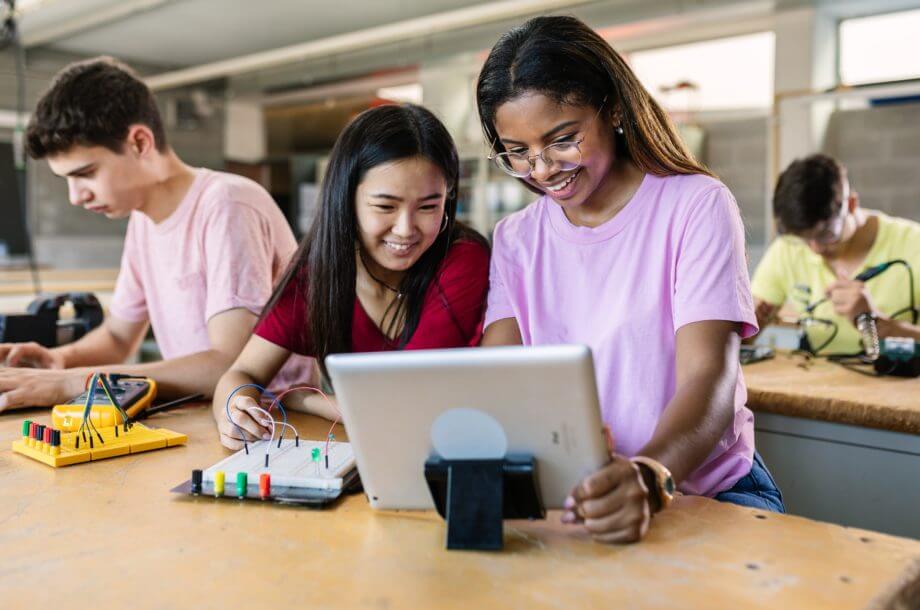 Two women looking at tablet whilst working on an engineering project