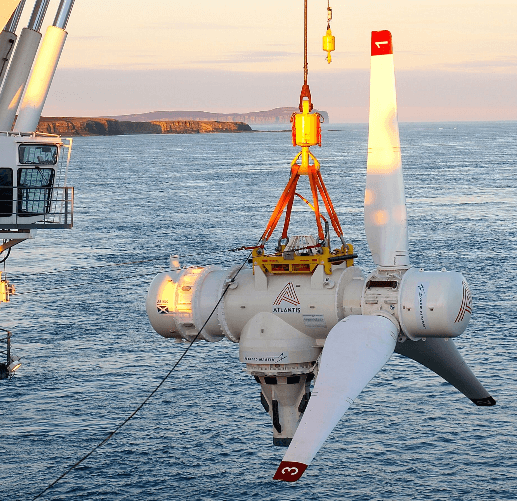 Wind turbine part being craned over the sea