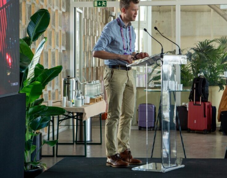 A speaker presenting at a podium